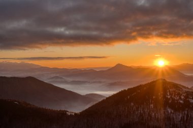Güneşin dağların üzerinden yükselişi, karla kaplı vadide inversiyon, Slovakya