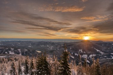 Taze bir karla dağ köyüne giden yol güneşin görkemli kırmızı ışığında. Soğuk kış vadisi. czech beskydy