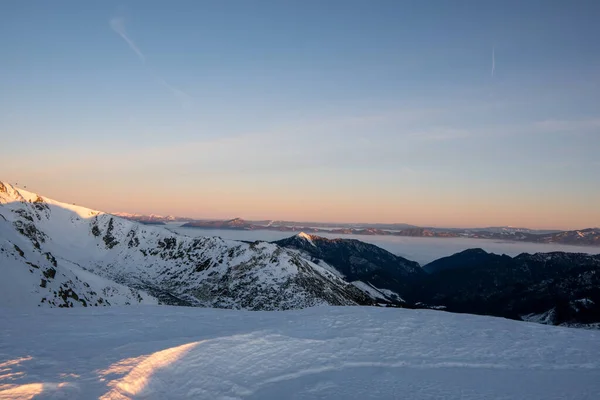 Sunrise in winter mountains with clear sky with view of High Tatras in background, Slovakia Low Tatras, dumbier