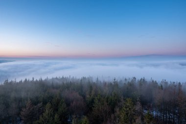 Gün doğmadan önce, sis bulutu içinde dağlarda manzara.