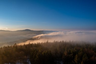 Çek Beskydy, gün doğumunda dağların tepelerinde sis perdesi aralanır.