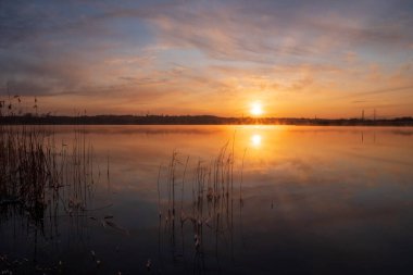 Gölün üzerinde güneşin gölün ve baharın üzerindeki yansımasıyla muhteşem bir gün doğumu.