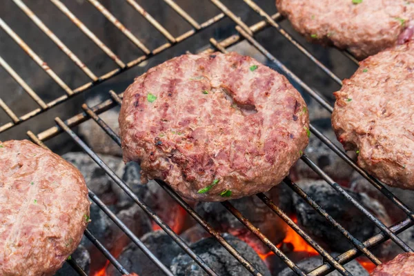 BBQ Grilled Burgers Patties On The Hot Flaming Charcoal Grill, Top View. Cookout Food, Good Snack For Outdoor Party Or Picnic