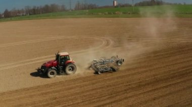 Stonava, Çek - 08 Nisan 2020: Traktör ekimi ve kuru bir tarla tohumu. Çiftçi, bahar başlarında tohum ekme faaliyetlerinin bir parçası olarak tohum ekicisiyle arazi hazırlıyor.