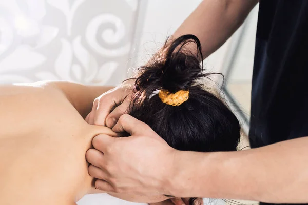 Man is doing neck massage to beautiful young woman at spa. Concept of healthy lifestyle. — Stock Photo, Image