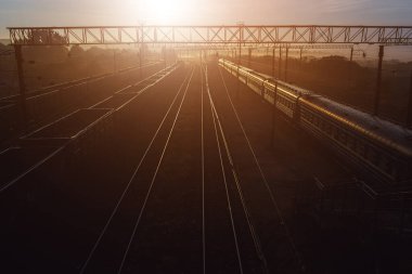 Yük ve yolcu treniyle tren istasyonunda güzel bir gün batımı.