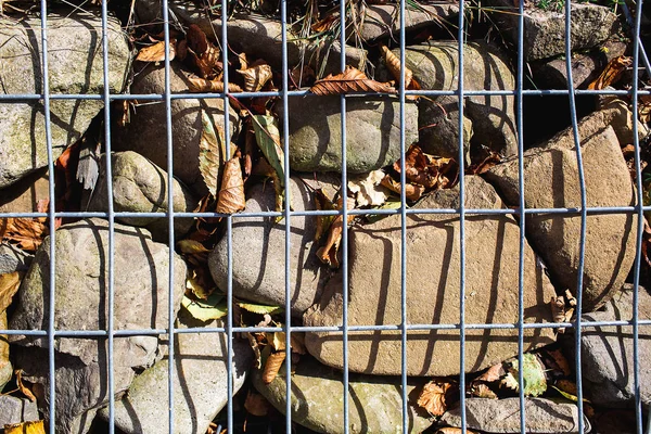 welded steel mesh filled with stones, closeup gabion.