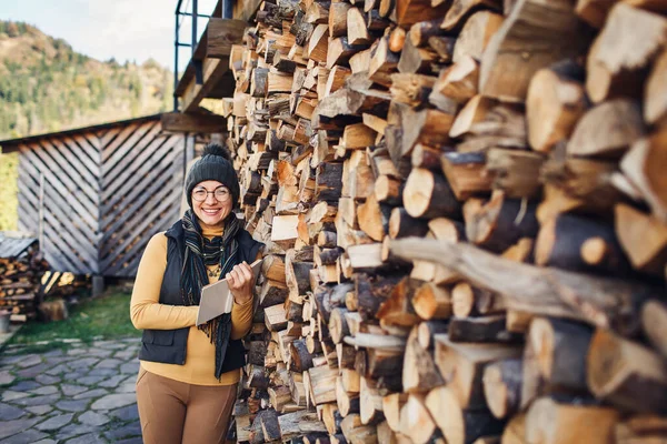 Cheerful Nerd Girl Glasses Stands Book Outdoors Stack Firewood — Stock Photo, Image