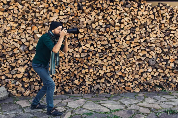 Bearded Man Photographs Digital Camera Background Wall Firewood — Stock Photo, Image