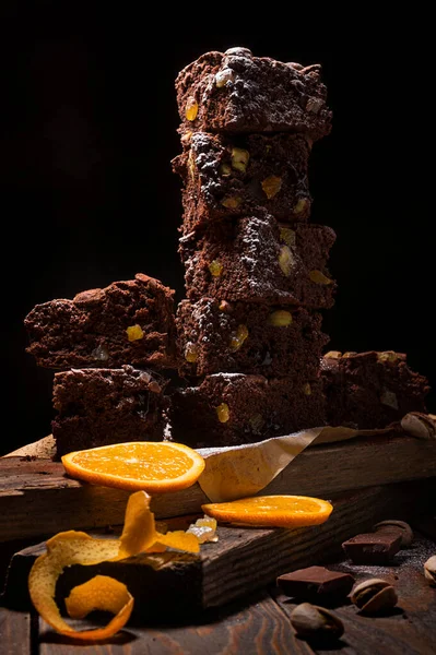 Stack Chocolate Brownies Wooden Background Orange Peels Pistachio Nuts Homemade — Stock Photo, Image