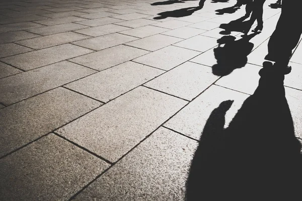 Shadow of office worker in day light on pattern granite city street — Stock Photo, Image
