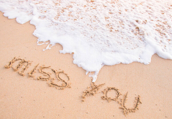 miss you, words on the sand, touching by moving wave 