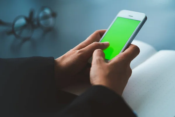 businessman using smart phone with green screen at office, connection concept