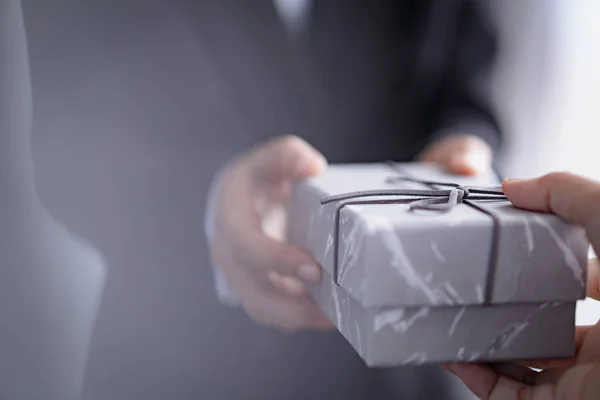 Businessman with gift box on occasion of celebration — 스톡 사진