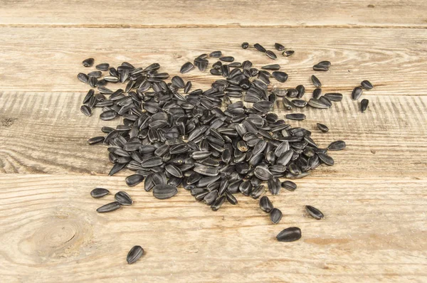 Sunflower seeds on a wooden background — Stock Photo, Image