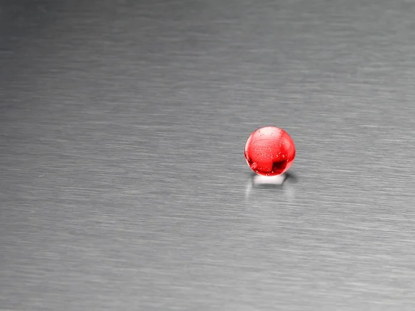 Red ball on an aluminum background — Stock Photo, Image