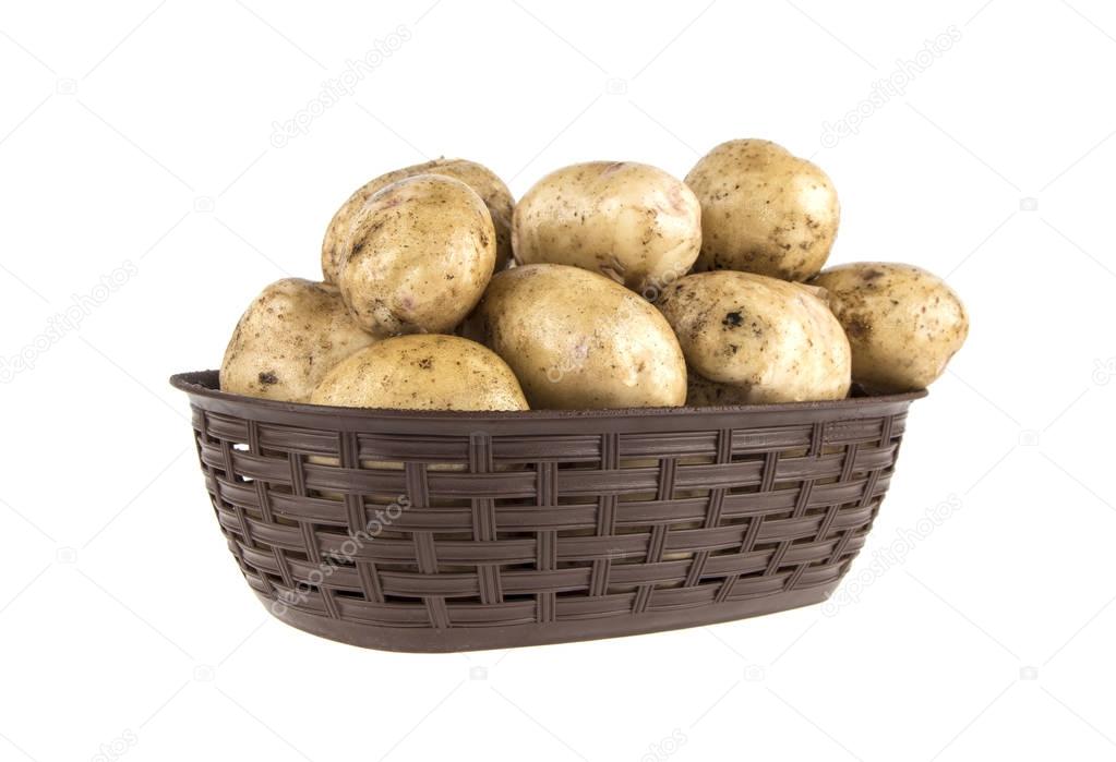 Young potatoes in a basket on a white background