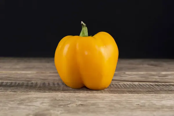 yellow pepper on a wooden table