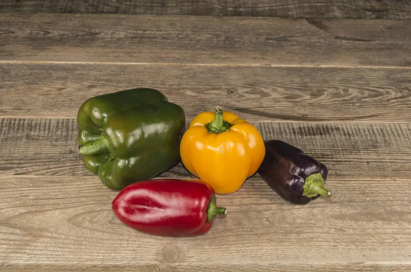 A few peppers on a wooden table — Stock Photo, Image