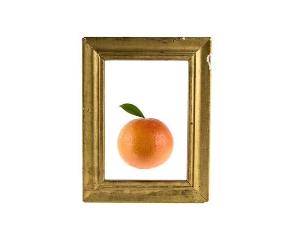 Grapefruit and wooden frame on a white background — Stock Photo, Image
