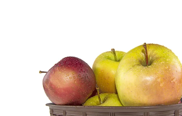 wet apples in a basket on a white background