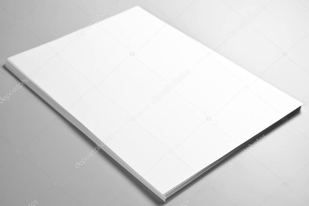 Pile of blank sheets of paper or letterheads over gray background