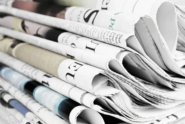 Pile of old folded newspapers, selective focus