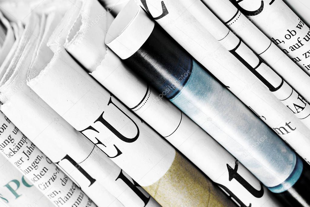 Close-up of standing folded newspapers 