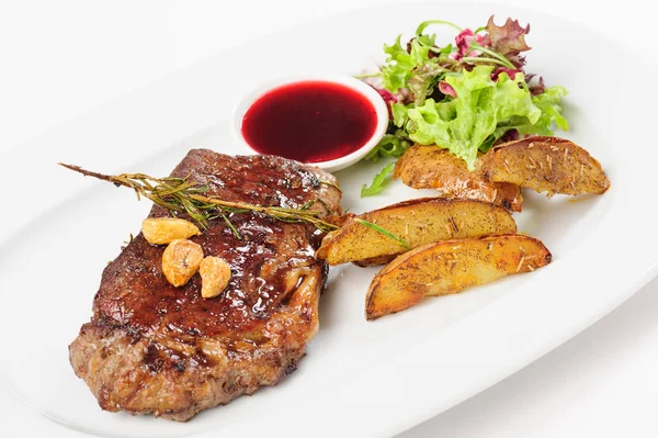 Thick juicy beef steak with potato and salad — Stock Photo, Image