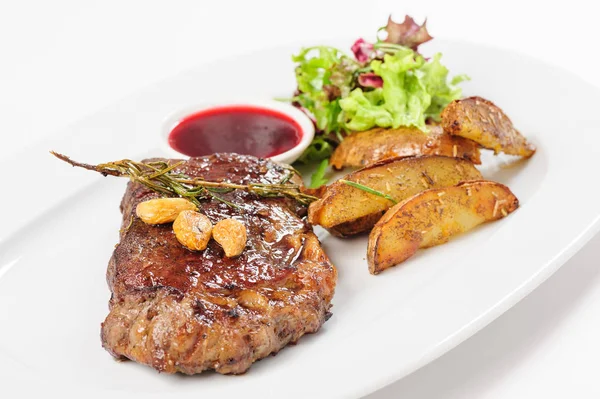 Thick juicy beef steak with potato and salad — Stock Photo, Image
