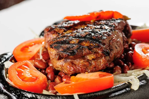 Beef steak with red beans garnish — Stock Photo, Image