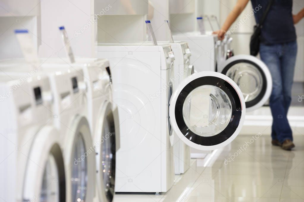 washing machines in appliance store and defocused buyer