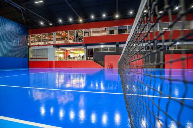 Blue colored empty indoor tennis court