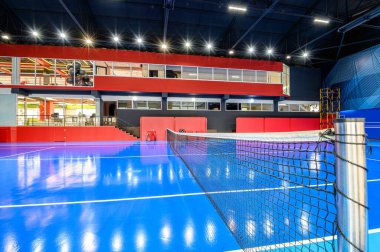 Blue colored empty indoor tennis court