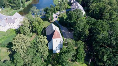 Cirava Lutheran Kilisesi Aizpute Letonya 'nın Hava Çekimi, Güneşli Yaz Günü. Kilisenin ve Malikâne 'nin üzerinde derinin yüzülmesi. Dışarıdan bakıldığında Kurzeme' nin diğer kiliselerine benziyordu. 