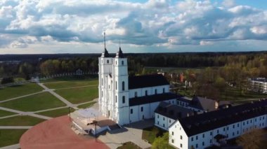 Letonya 'daki Görkemli Aglona Katedrali. Beyaz Chatolic Kilisesi Bazilikası. Güneşli Bahar Günü Mavi Gökyüzü ve Beyaz Bulutlar. Letonya 'nın en önemli Katolik Ruhsal Merkezlerinden biri.