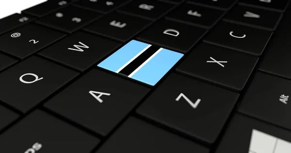 Botswana flagga knappen på laptop tangentbord. — Stockfoto
