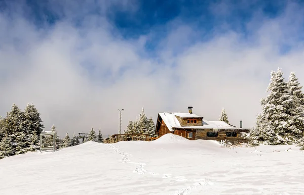 Wooden cabin as a restaurant near the ski piste on mountain ranges under the snow, mountain Kopaonik, Serbia