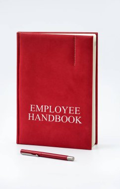 Employee Handbook or manual with a pen and paper on a white table in an office - personnel management policy, explains business goals, results, defines personnel practices clipart