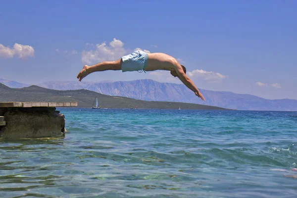 Swimmer jumping to sea water — Stock Photo, Image