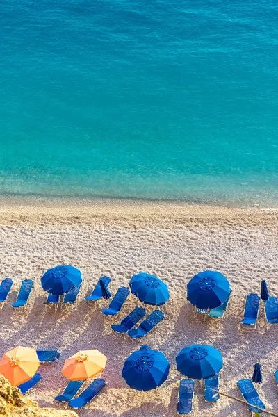 Blue umbrellas and blue sea - Greece, Lefkada island — Stock Photo, Image