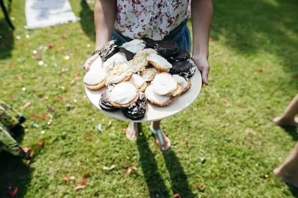 stock image High angle view of female holding tray with donuts at sunny yard