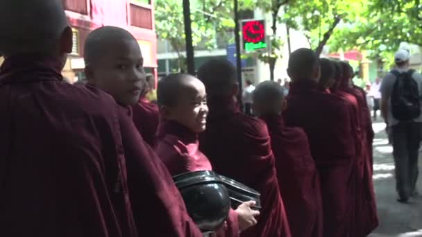 Young Buddhist monks on streets — Stock Video