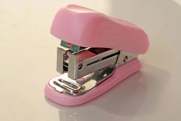Pink stapler tool. Pink office tool.