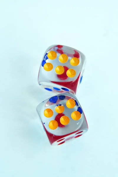 Glass made dices. Transparent glass dices. Colorful dots and transparent dices.