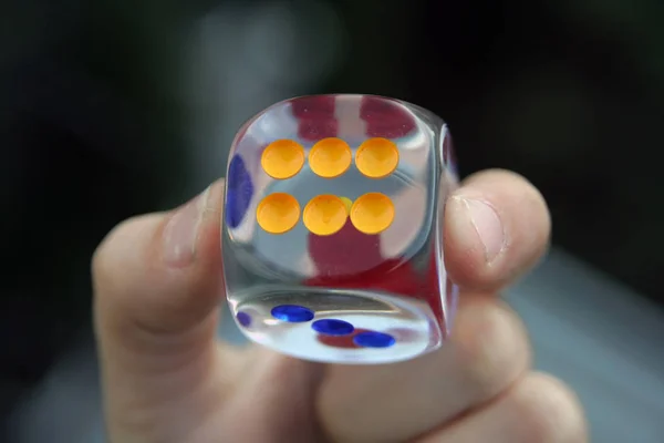 Kid holding dice in his hand. Dice in kids hand.