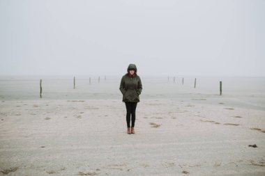 Kış döneminde sahilde duran kadın