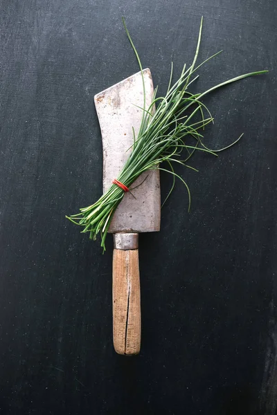 Chive on vintage meat cleaver — Stock Photo, Image