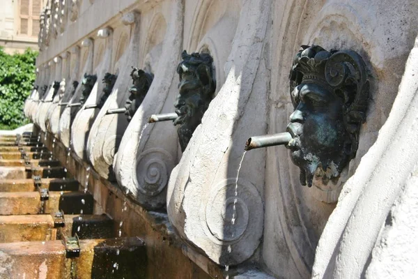 Historical fountain with bronze faces in Ancona, italy