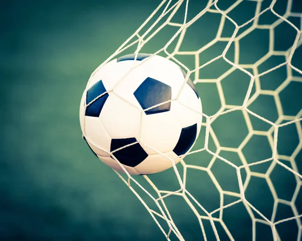 soccer ball in goal net - retro vintage filter effect
